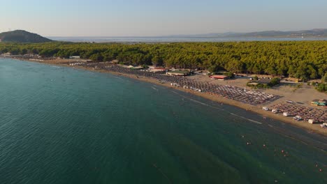 narta beach in albania with clear sea, beautiful sand, and surrounding homes, aerial view