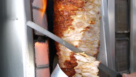 Street-food,-a-man-slicing-grilled-meat