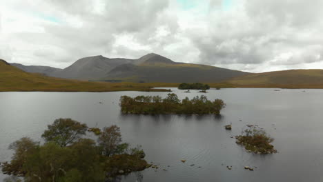 drone shot flying over lochan na h-achlaise with mountains in background