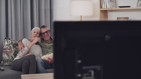 couple watching movie with popcorn