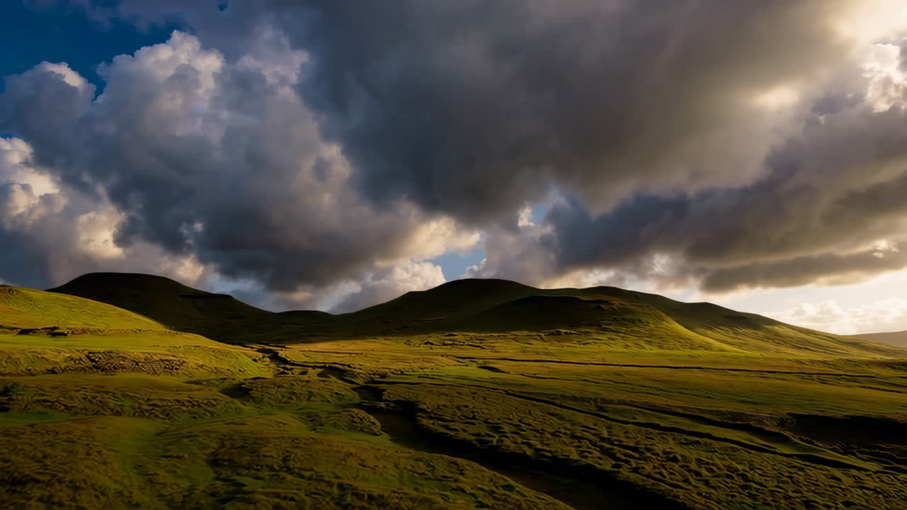 Dramatic Landscape with Green Hills and Cloudy Sky