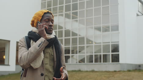 african american man speaking on mobile phone outdoors