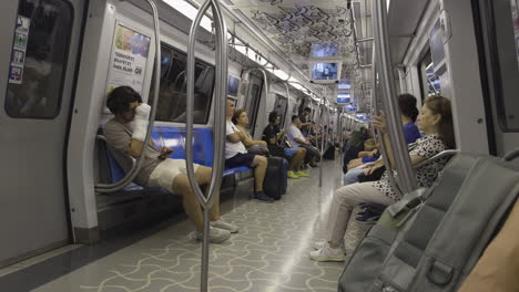 interior shot of a subway train in motion, with passengers sitting and standing, capturing daily commute in an urban setting