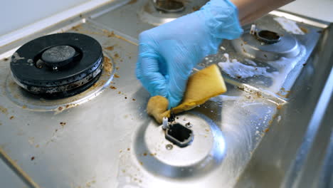 dirty kitchen stove surfaces. dirty stove shows food residues and grime, with cleaning products on metal surfaces, hinting at recent use