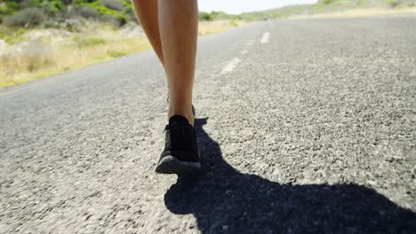 Low-section-of-triathlete-man-jogging-in-the-countryside-road