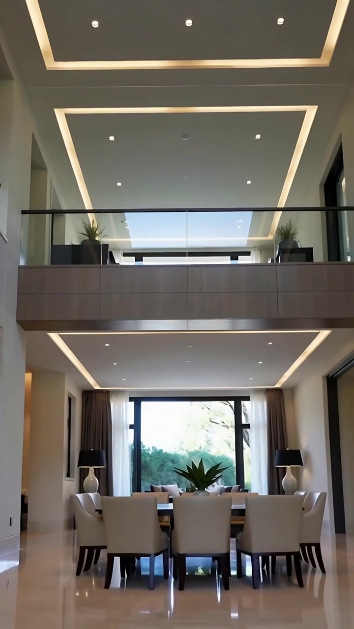 Vertical video: Tilting camera revealing home dining area, showing wood mezzanine and glass railing