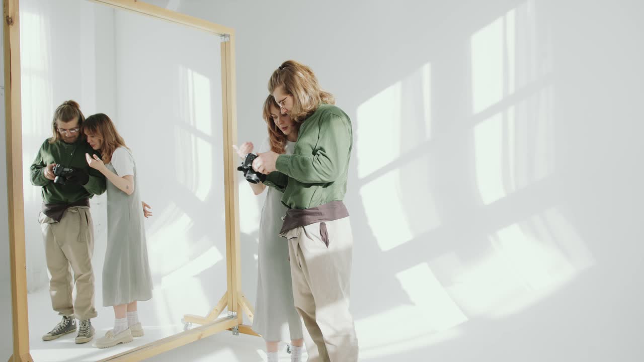 Female Model and Photographer Discussing Photos on Camera in Studio