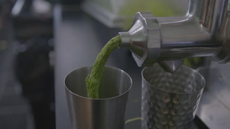 close up dolly in of a wheatgrass juicer