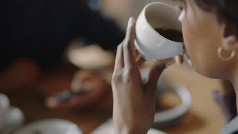 close-up-business-woman-hands-drinking-coffee-in-cafe-enjoying-hot-beverage-colleagues-relaxing-after-work