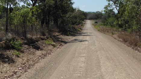 drone flying low altitude over rural and unpaved road at st lawrence, clairview in australia