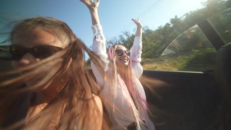 friends enjoying a sunny convertible road trip