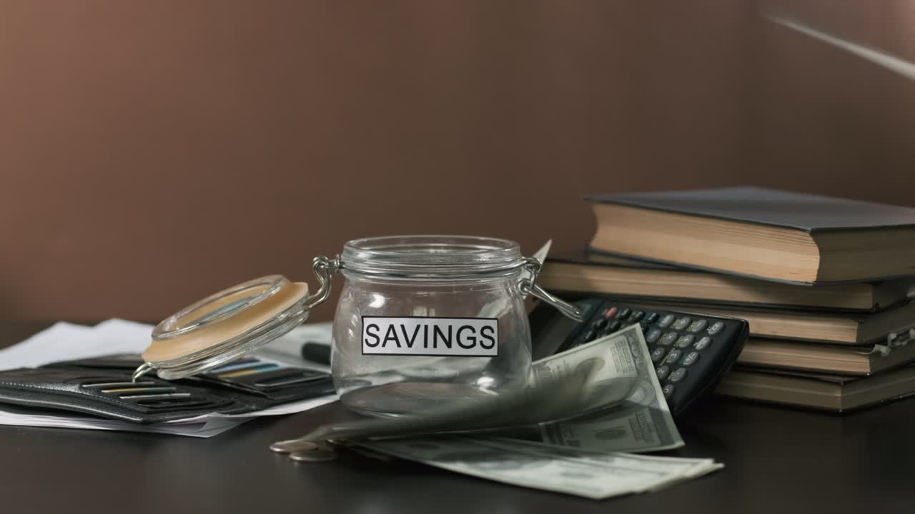 Money Falling from Above near Glass with Savings