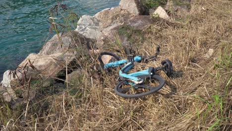 discarded hire rental bike in beside river in tseung kwan o in hong kong