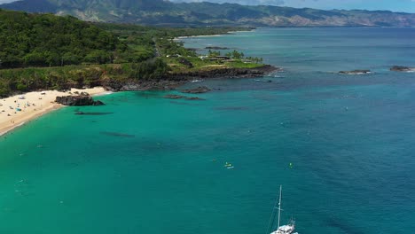 panning aerial view of waimea bay and the north shore, on the island of oahu, hawaii