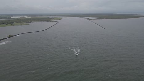 Fishing-Boat-Heading-Out-In-The-Ocean-To-Catch-Fish-In-Bundaberg,-Queensland,-Australia