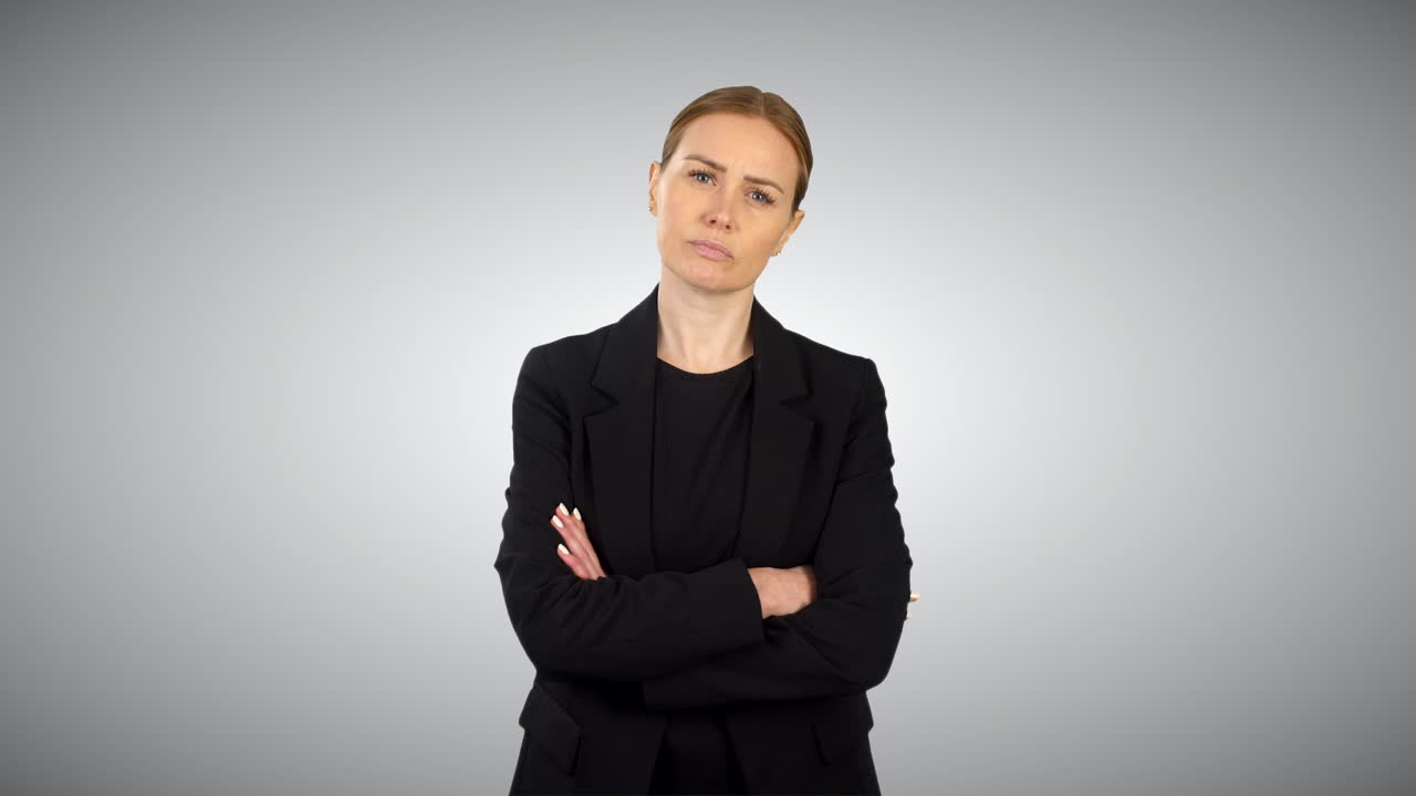A Serious Angry Business Woman Folding Arms With White Studio Background