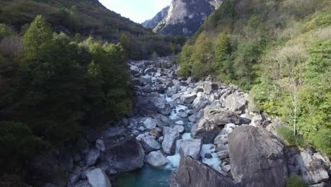 aerial view of crystal clear turquoise mountain river verzasca valley in swiss alps