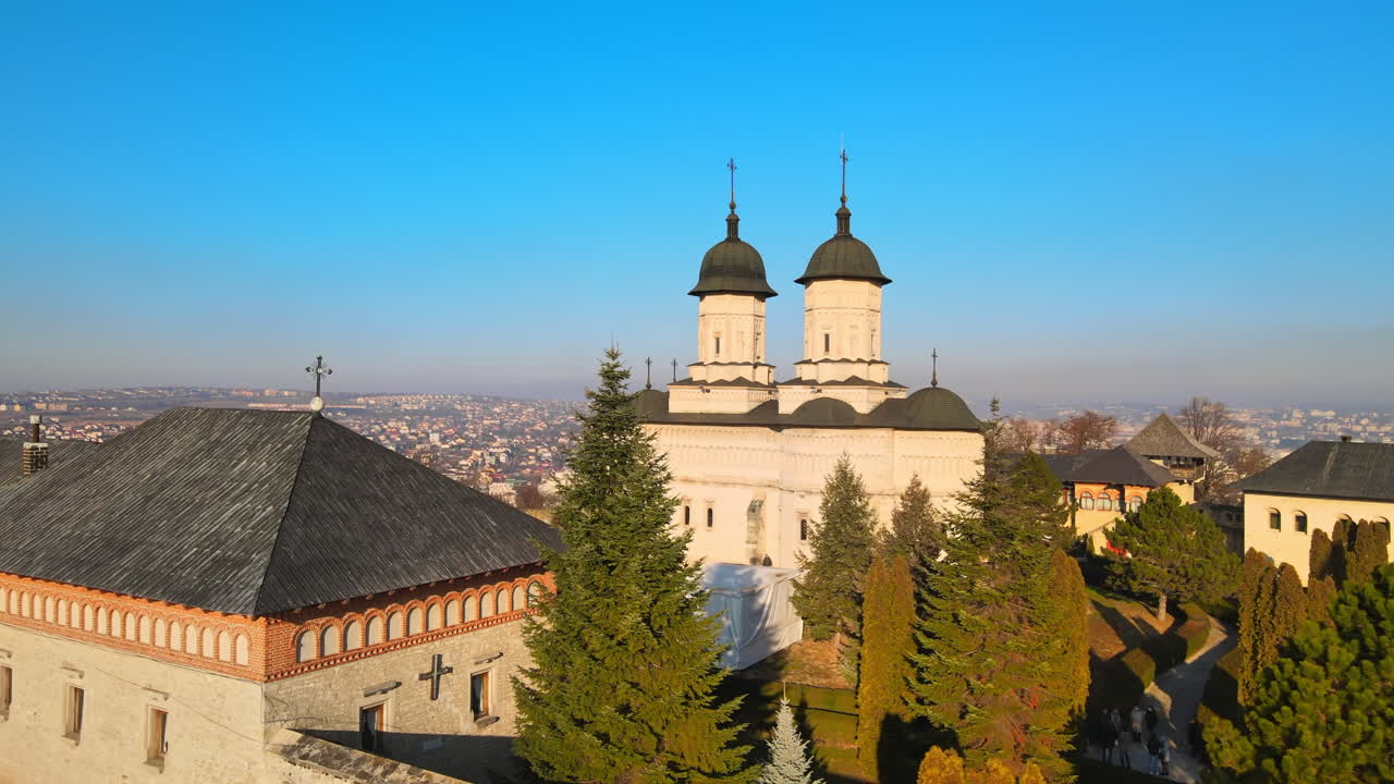 Aerial drone view of the Cetatuia Monastery in Iasi, Romania. Main church, inner court and ancient walls, city on the background