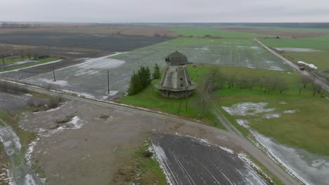 beautiful aerial establishing view of old wooden windmill in the middle of the field, prenclavu windmill , overcast winter day, wide drone shot moving forward, tilt down