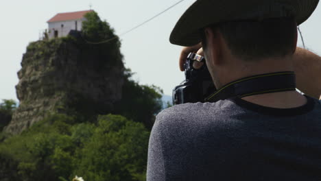 male photographer with camera taking picture of tsveri st