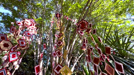 vibrant mobiles hanging from trees in thailand