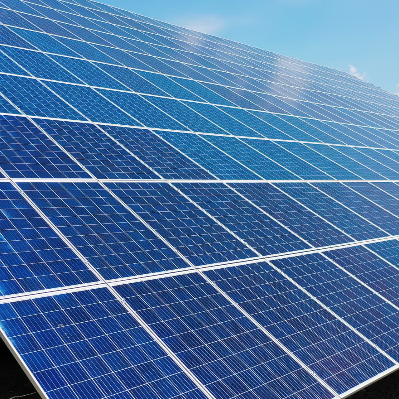 Close-up of solar panel collecting sunlight. Ecology innovation of clean sun energy. Blue solar device on the ground.