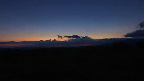 Lapso-De-Tiempo,-Nubes-Moviéndose-A-Través-Del-Cielo-Al-Atardecer-Hasta-El-Anochecer,-Horizonte-Y-Montañas,-Vietnam