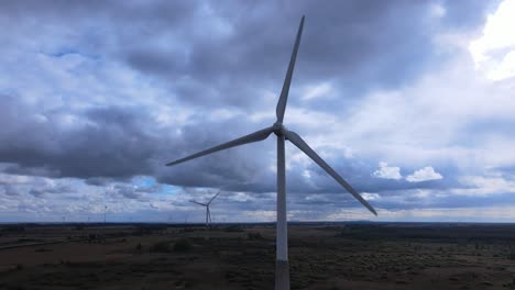 Windmill-blades-on-sunny-day,-drone-shot-close-up-4K