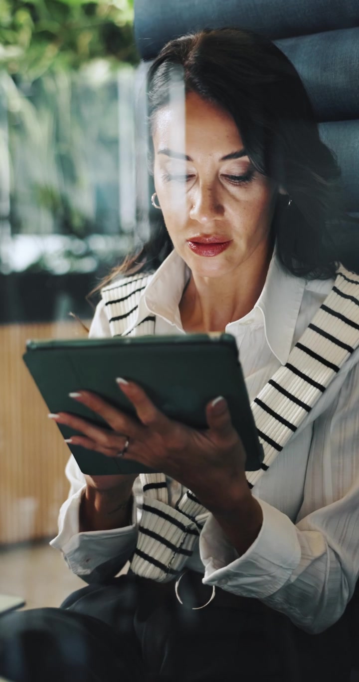 Professional Woman Using Digital Tablet in Modern Office