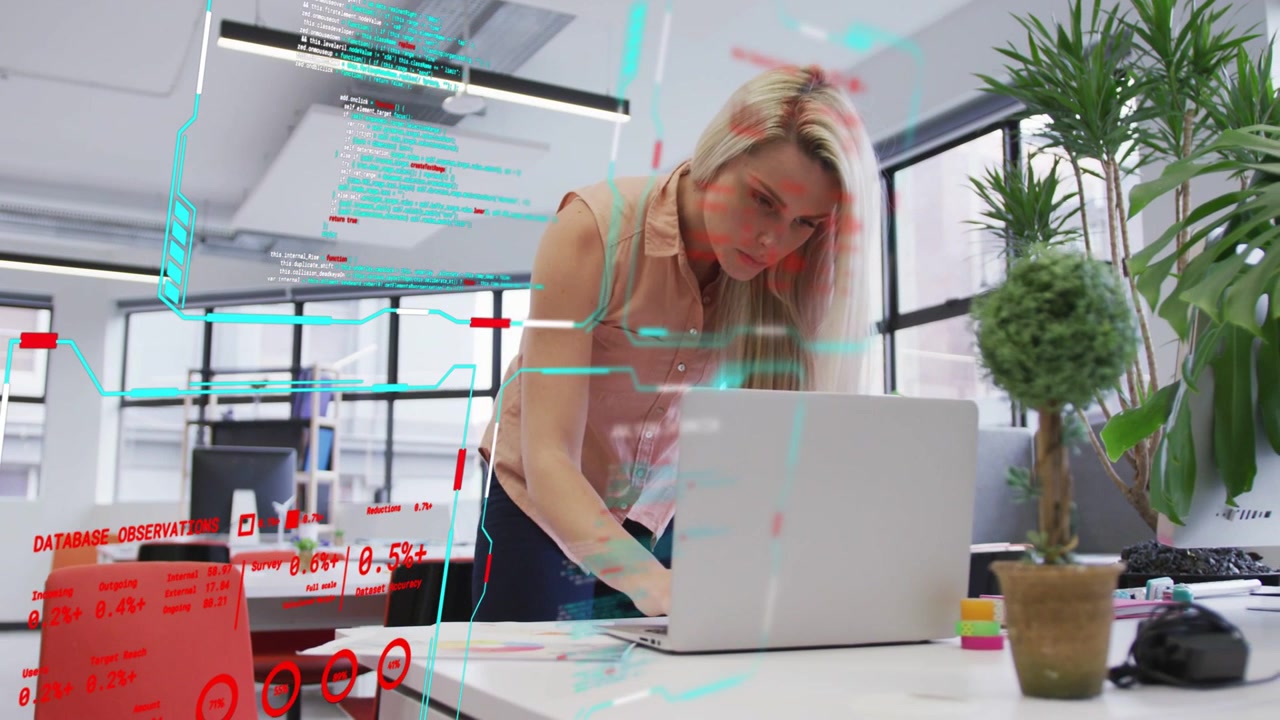 Woman leaning over laptop, tapping pad after reading papers, HUD over desk showing finance data