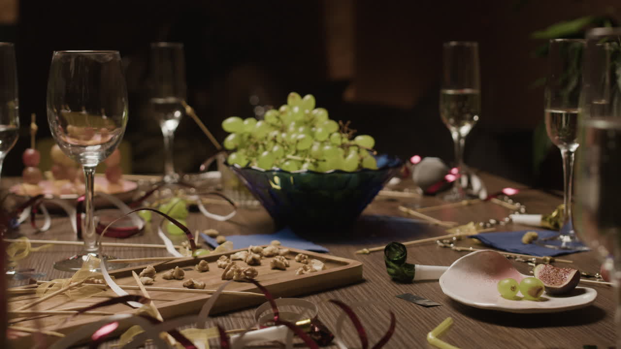 Party table with grapes, wine glasses, and decorations