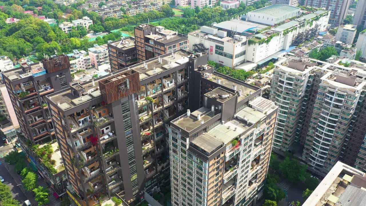 Aerial view of Manhattan nature giant dollhouse apartment building during the day in Chengdu, province of Sichuan, China, establishing drone shot