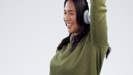 Dance,-headphones-and-happy-Asian-woman-on-a-white