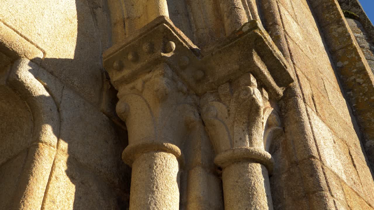 Close-up of intricately carved stone columns on an ancient building