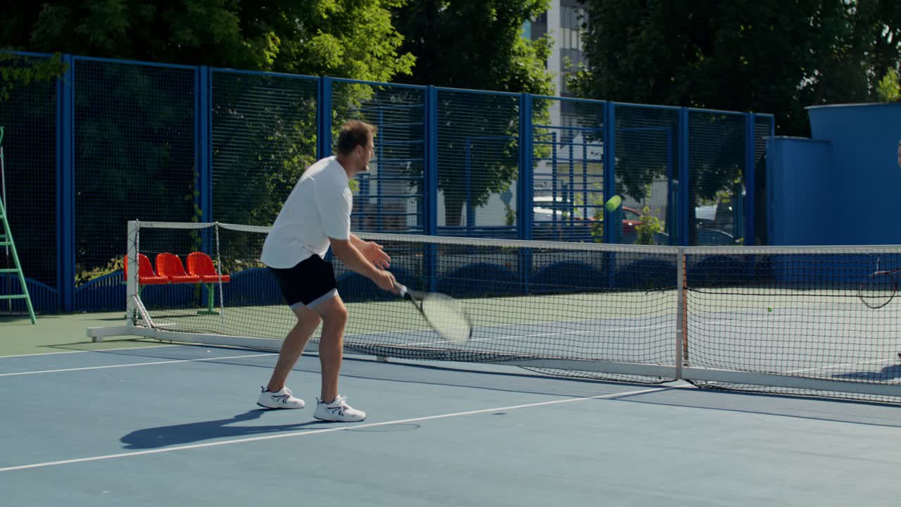 Men playing tennis outdoors