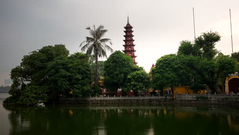 tran quoc pagoda in hanoi, vietnam, scenic views of the surrounding lake and greenery, pan from left to right