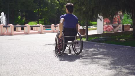 young disabled man moving in wheelchair in slow motion.