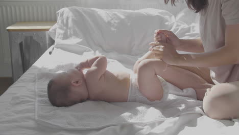 cute baby and happy mom in bed