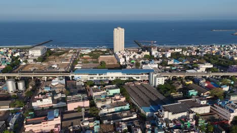 drone shot capturing dense urban landscape of north chennai in evening light