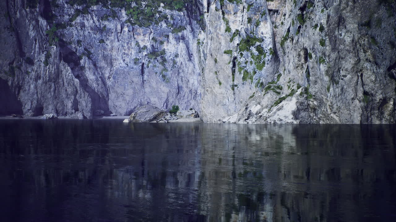 Crystal clear waters reflect majestic cliffs beside tranquil shore