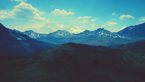 mountain gorge with green meadow illuminated by the sun