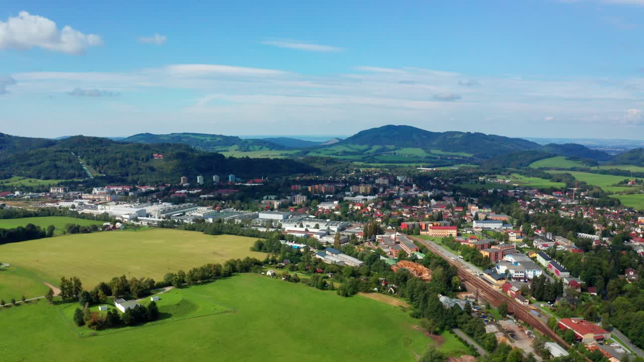 Right side drone shot of czech small city with beskydy mountains