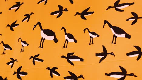 animated bird patterns on an orange background