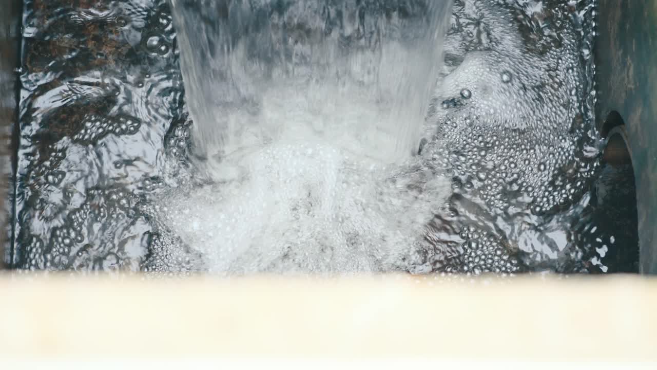 Outflow of treated water, representing purification, environmental protection, clear environment.