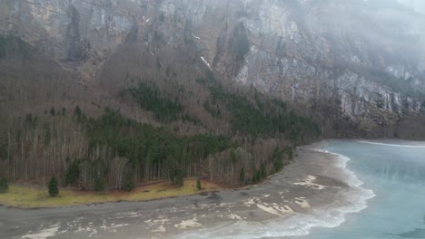 Klöntalersee-Glarus-Switzerland-pull-back-reveals-the-mist-lake-and-forest