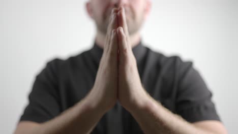 man holds up hands to beg for mercy close-up