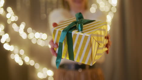 proud and happy woman hands over a present