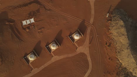 4k: aerial footage of luxury glamping tents along the rock in the faya desert in sharjah, united arab emirates