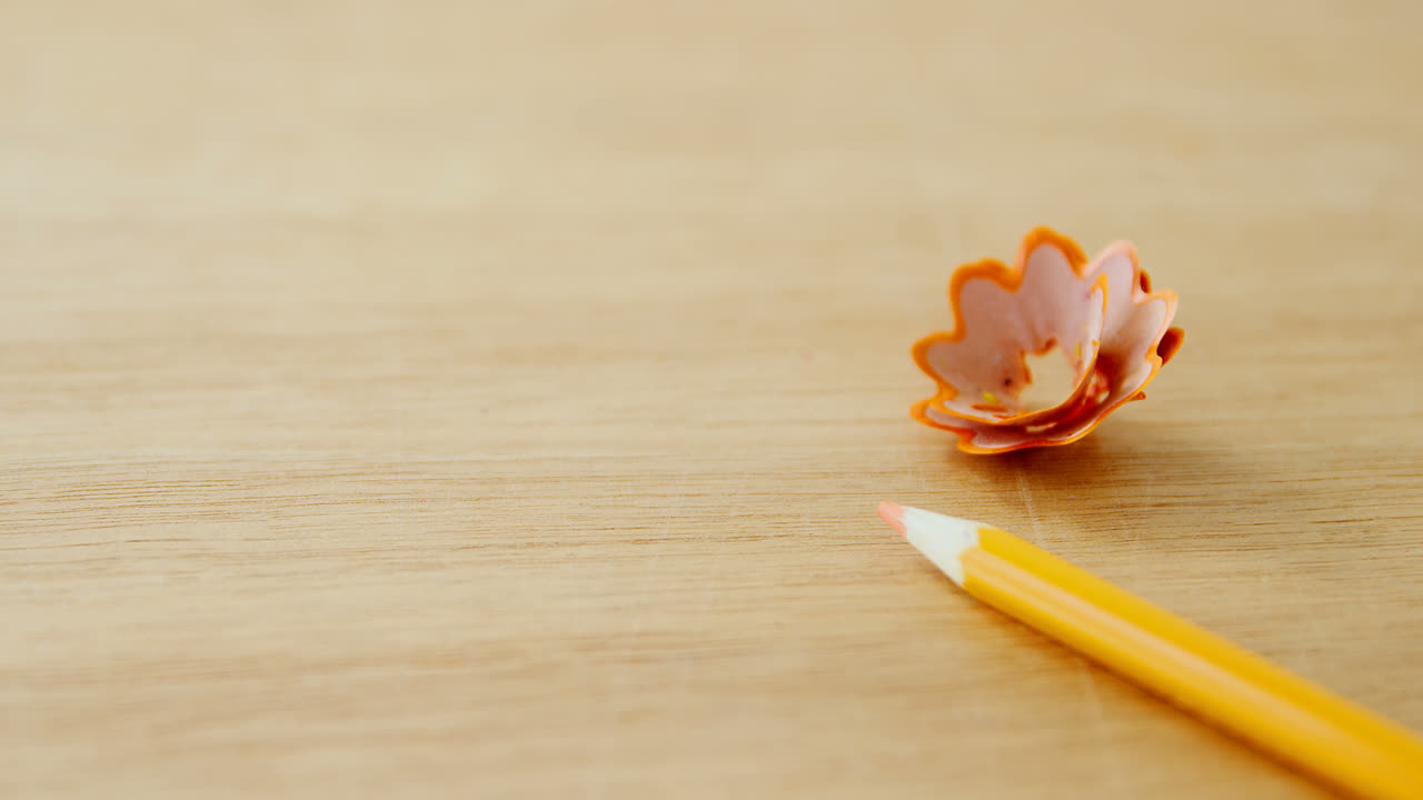 Close-up of yellow colored pencil with shavings