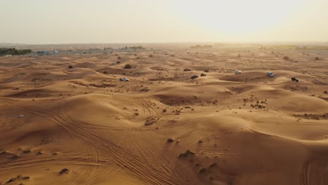 aerial view of desert landscape with off-road vehicles